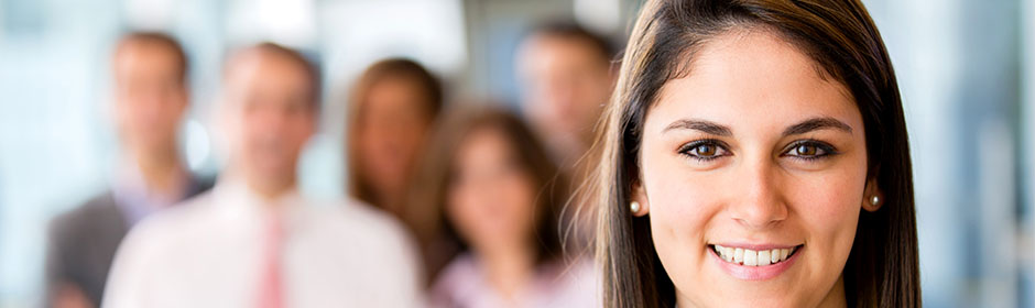 Woman smiling while a team stands behind her